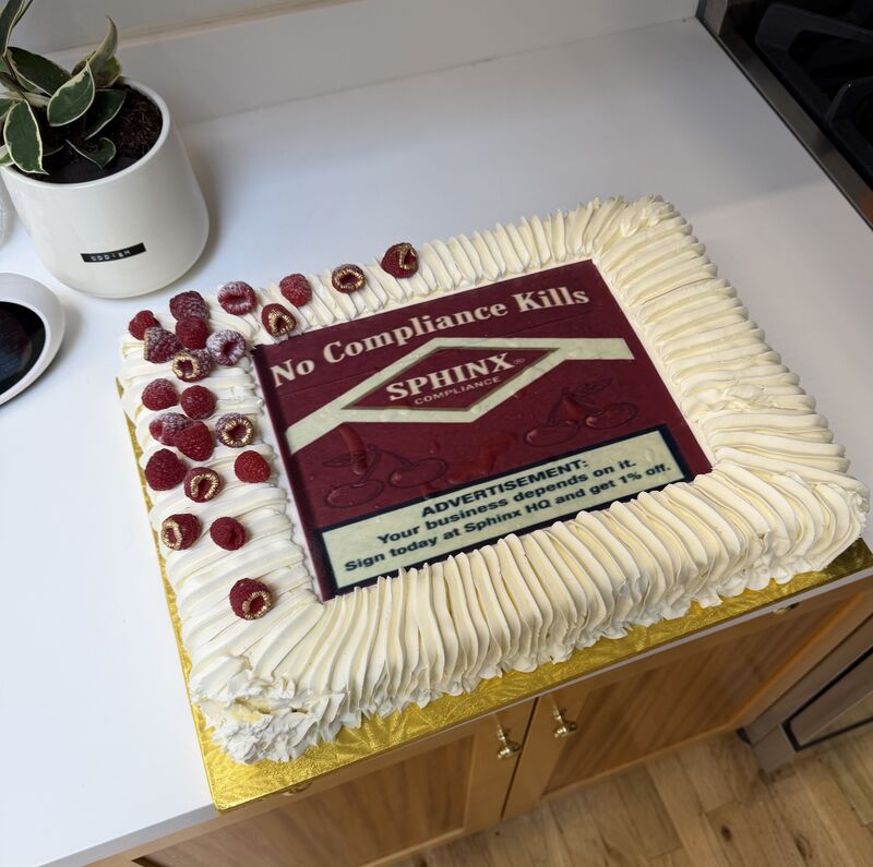 A sheet cake with a printed design: a short headline, a logo and two lines of body copy, all readable from across the table