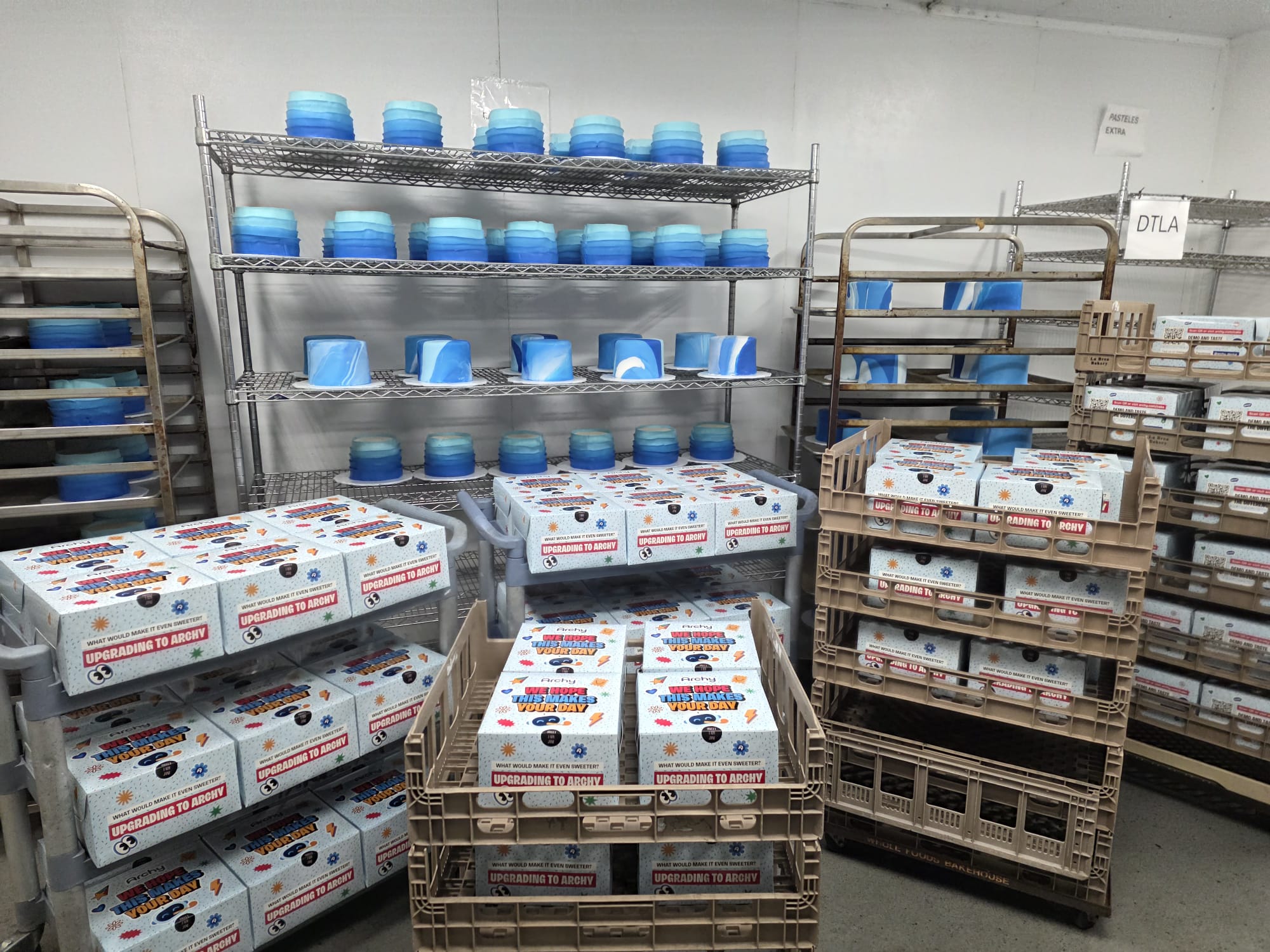 Bakery racks stacked with boxed cakes, ready to go out