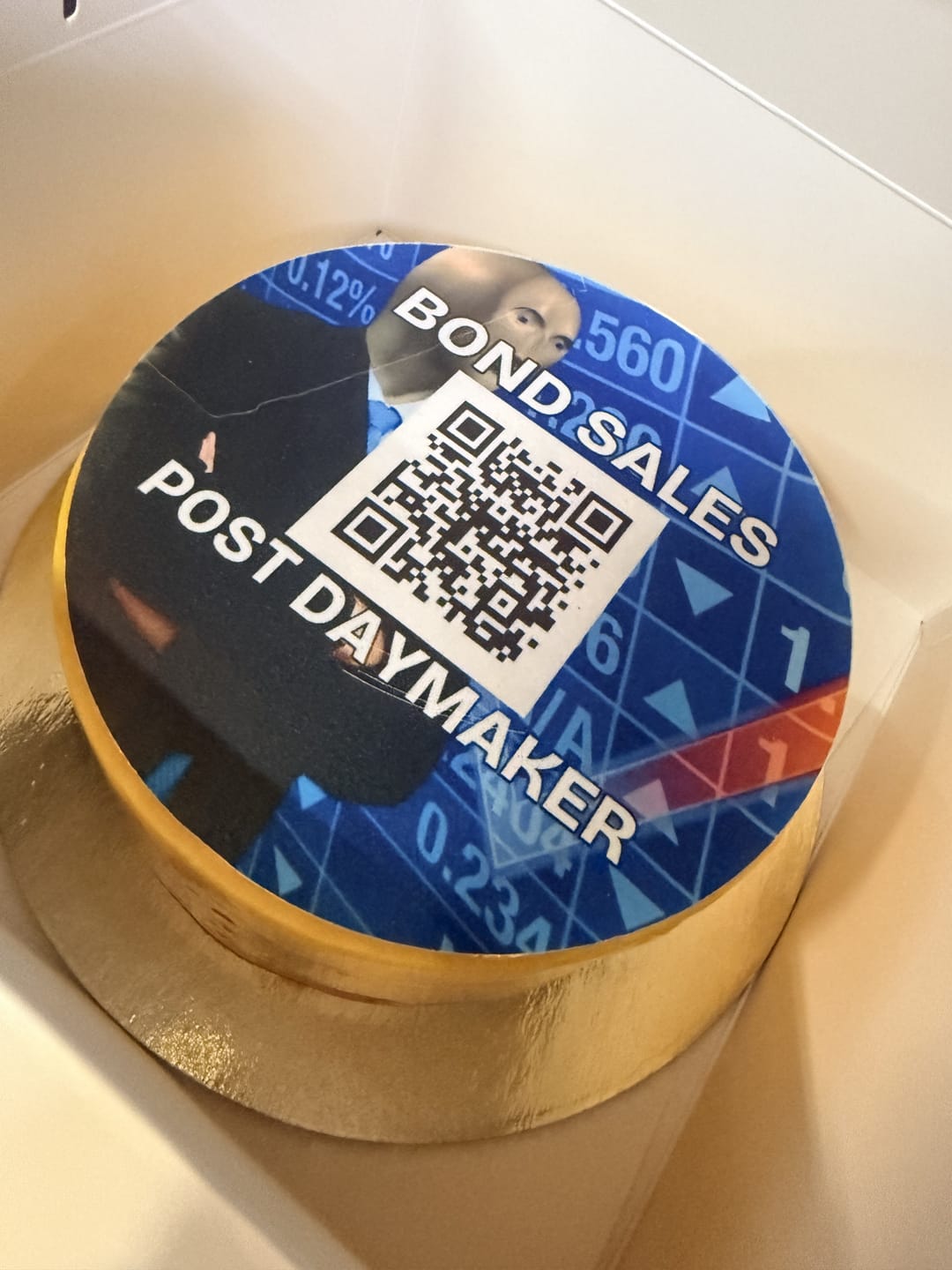A blue printed cake with a QR code