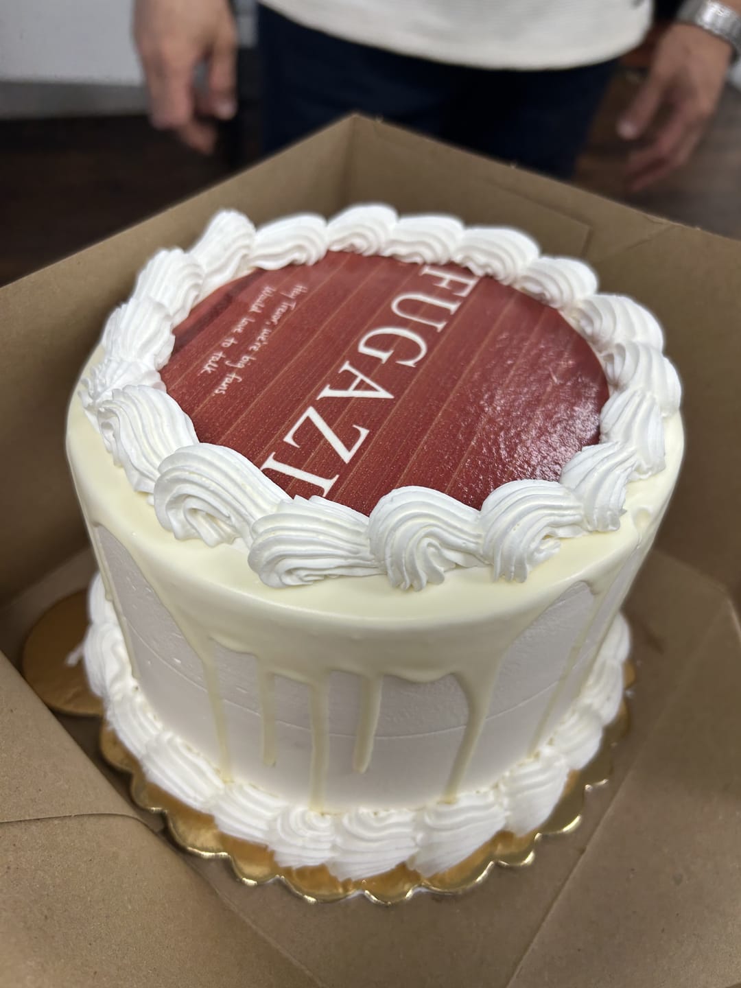 A tall white cake with a red Fugazi top