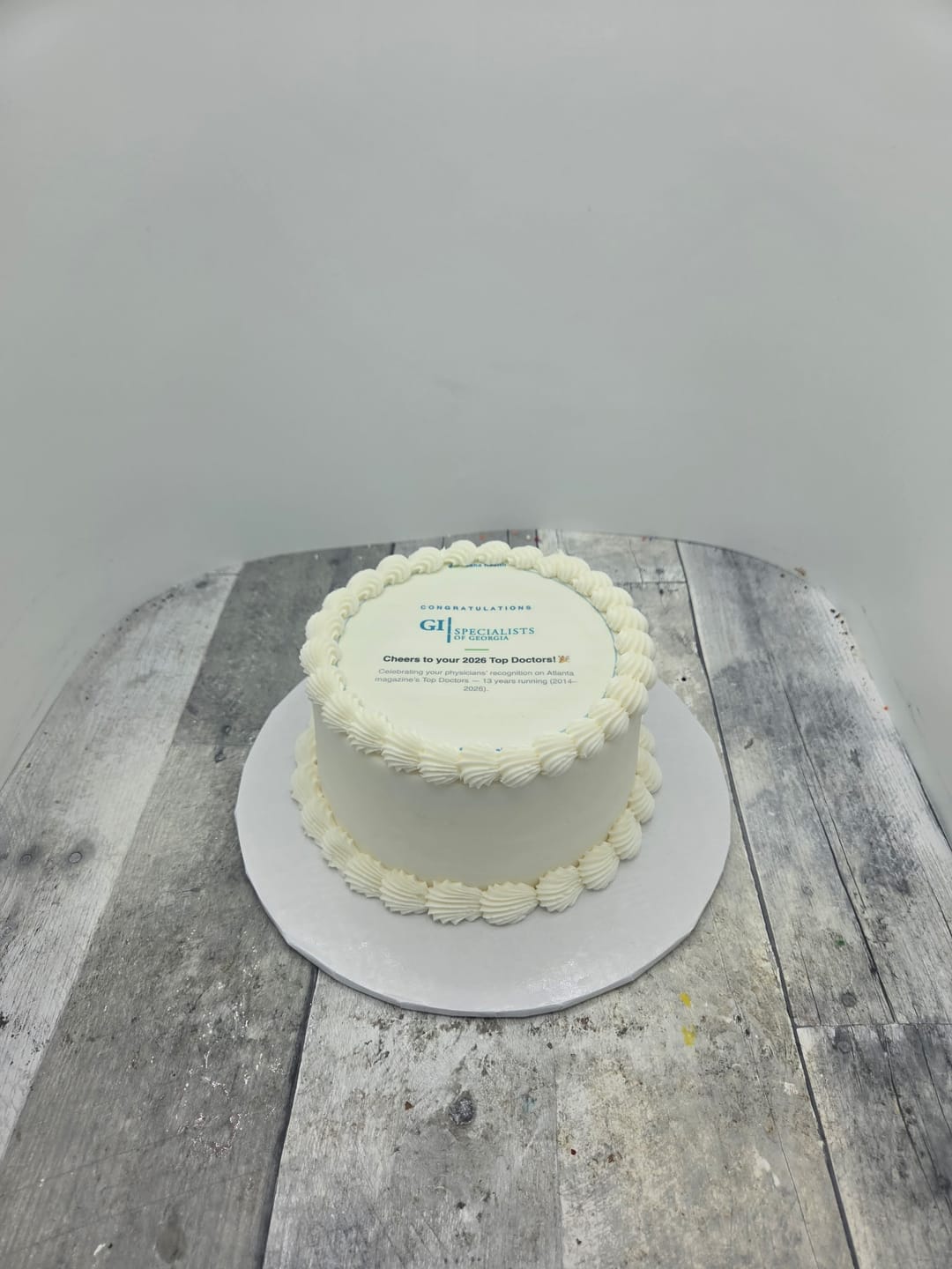 A small white cake with a printed top
