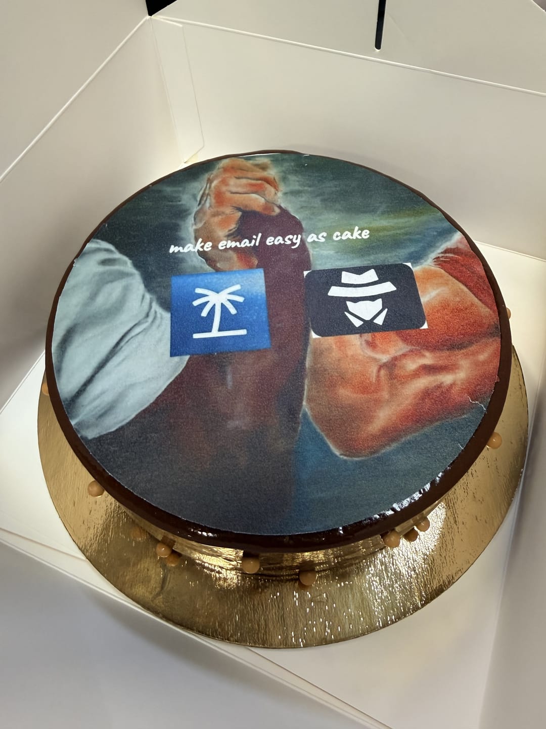 A cake printed with two arms arm-wrestling