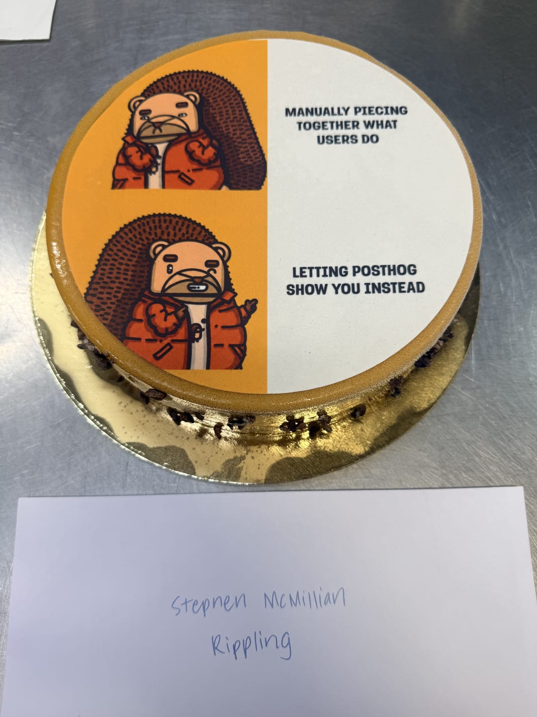 A cake printed with a two-panel PostHog meme