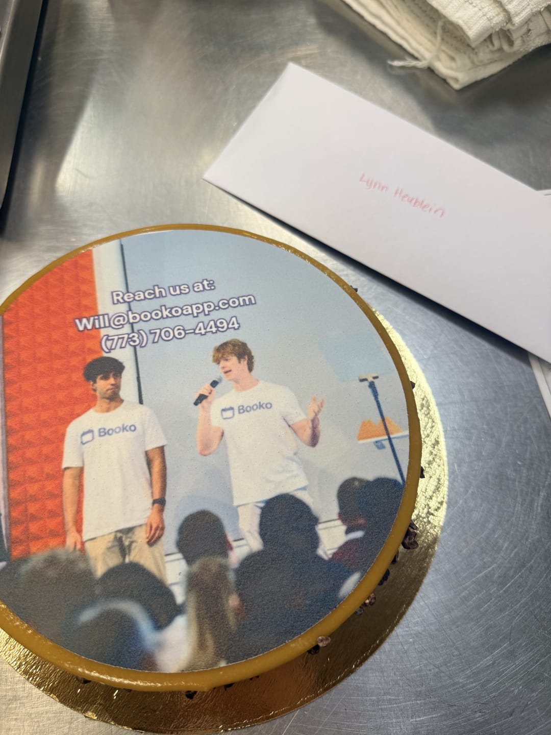 A cake printed with a photo of two people on stage