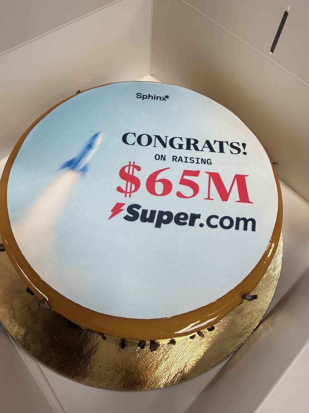 A cake printed with Congrats on raising $65M, Super.com